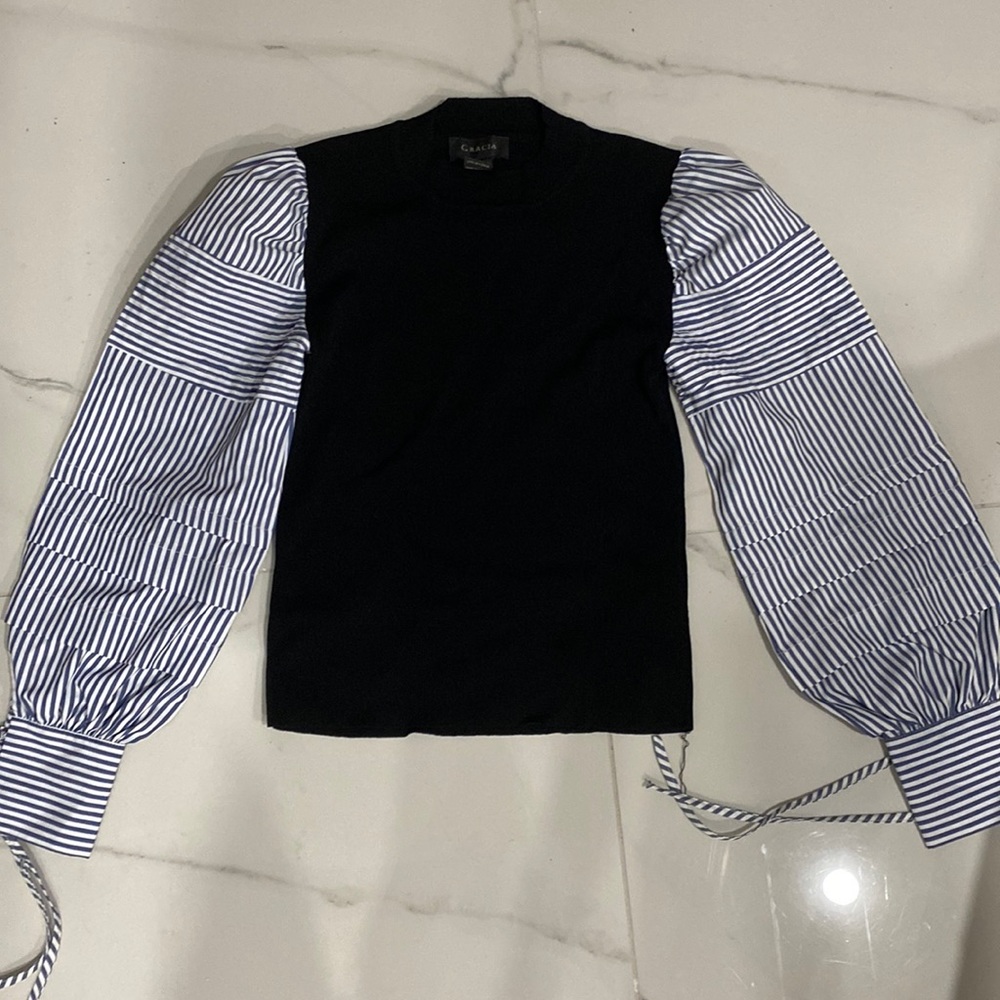 Black shirt with white and blue stripped sleeves